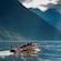 Guests cruising on a wooden tour boat through the waters around Alesund
